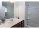 Bright bathroom featuring a vanity with dark cabinets and a shower-tub combination at 5200 Beckom St, Raleigh, NC 27616