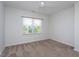 Cozy bedroom with neutral carpet, a ceiling fan, and a window offering pleasant views at 5200 Beckom St, Raleigh, NC 27616