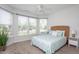 Bright bedroom features many windows and a comfortable bed with a patterned comforter at 5200 Beckom St, Raleigh, NC 27616