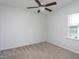 Bedroom with neutral carpet, a ceiling fan, and natural light from a window at 5200 Beckom St, Raleigh, NC 27616