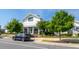 Exterior view of a modern, white clubhouse with well-kept landscaping and a paved parking area at 5200 Beckom St, Raleigh, NC 27616
