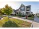 Charming two-story home with gray siding, well-manicured lawn, and colorful flower beds for a welcoming curb appeal at 5200 Beckom St, Raleigh, NC 27616