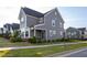 Lovely home showcasing stone accents, gray siding, well-maintained lawn, and walkway to the front door at 5200 Beckom St, Raleigh, NC 27616