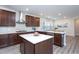 Bright kitchen boasts stainless steel appliances, white countertops, and dark wood cabinets at 5200 Beckom St, Raleigh, NC 27616