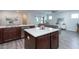 Open-concept kitchen flows into the living room with stainless steel appliances and center island at 5200 Beckom St, Raleigh, NC 27616