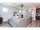 Comfortable living area features gray sofa, wood floors, art and an open-concept layout at 5200 Beckom St, Raleigh, NC 27616
