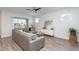 Bright living room features a gray sofa, stylish decor, and natural light with a sliding glass door at 5200 Beckom St, Raleigh, NC 27616