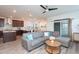 Open-concept living area with wood floors, a gray sofa, and eat-in kitchen at 5200 Beckom St, Raleigh, NC 27616