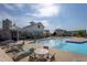 Community pool featuring a modern clubhouse, lounge chairs, and clear blue water, perfect for relaxation at 5200 Beckom St, Raleigh, NC 27616
