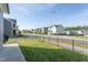 Street view of the house with a neat lawn and black metal fence at 5200 Beckom St, Raleigh, NC 27616