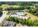 Community aerial view featuring a pool, clubhouse, playground, and well-maintained landscaping and surrounding green space at 521 Marion Hills Way, Knightdale, NC 27545