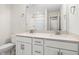 Modern bathroom with dual sinks, white cabinetry, quartz countertops, and large mirror at 521 Marion Hills Way, Knightdale, NC 27545