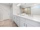 Bathroom featuring double sinks, white cabinetry and quartz countertops at 521 Marion Hills Way, Knightdale, NC 27545