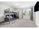 Spacious carpeted bedroom with bunk beds, a desk, and a window with backyard views at 521 Marion Hills Way, Knightdale, NC 27545