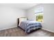 Bright carpeted bedroom with a queen-size bed and a window overlooking the backyard at 521 Marion Hills Way, Knightdale, NC 27545