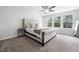 Bright carpeted bedroom with a queen-size bed and large windows for natural light at 521 Marion Hills Way, Knightdale, NC 27545