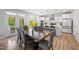 Open floorplan combines dining and kitchen with wood table and seamless flow to outdoor patio at 521 Marion Hills Way, Knightdale, NC 27545