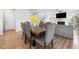 Dining area with wood table, upholstered chairs, and bright yellow floral centerpiece at 521 Marion Hills Way, Knightdale, NC 27545