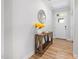 Bright entryway with hardwood floors, a wooden console table, and a decorative mirror at 521 Marion Hills Way, Knightdale, NC 27545