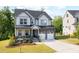 Charming two-story home with stone accents, a covered porch, and a well-manicured lawn at 521 Marion Hills Way, Knightdale, NC 27545