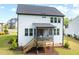 Rear exterior view of home featuring a screened porch with steps to the yard at 521 Marion Hills Way, Knightdale, NC 27545