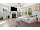 Bright living room featuring a fireplace, large windows, and comfortable gray sectional sofa at 521 Marion Hills Way, Knightdale, NC 27545