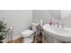 Cozy powder room with a pedestal sink, decorative mirror, and stylish accents at 521 Marion Hills Way, Knightdale, NC 27545