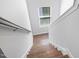 Bright staircase with hardwood steps, white risers, and a window for natural light at 521 Marion Hills Way, Knightdale, NC 27545