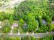 An aerial view of lush green trees surrounding single-Gathering homes and manicured green space in a quiet neighborhood at 529 Orindo Dr, Durham, NC 27713