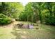 Landscaped backyard with a small footbridge and storage sheds at 529 Orindo Dr, Durham, NC 27713
