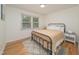This cozy bedroom offers natural light, hardwood floors, and a comfortable rug at 529 Orindo Dr, Durham, NC 27713
