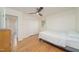 A bright bedroom featuring hardwood floors, a ceiling fan, and a double door closet at 529 Orindo Dr, Durham, NC 27713