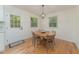 Charming dining area featuring hardwood floors and a round wooden table with seating for four at 529 Orindo Dr, Durham, NC 27713