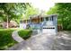 Charming home with a blue painted brick exterior, wooden accents, and an attached garage at 529 Orindo Dr, Durham, NC 27713