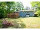 Rear exterior of the home with a wooden deck and lush backyard at 529 Orindo Dr, Durham, NC 27713