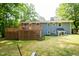 Rear exterior view of the home and backyard, showcasing the wooden deck at 529 Orindo Dr, Durham, NC 27713