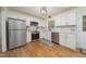 Modern kitchen with white cabinets, stainless steel appliances, and hardwood floors at 529 Orindo Dr, Durham, NC 27713
