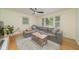 Inviting living room with a cozy gray sectional sofa, wood floors, and large windows at 529 Orindo Dr, Durham, NC 27713