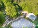 Aerial view of a property featuring a barn, riding arena, surrounded by lush greenery and mature trees at 54 Malcolm Neal Path, Louisburg, NC 27549