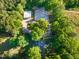 An aerial view of the residence nestled within a forest, including a barn and horse riding arena at 54 Malcolm Neal Path, Louisburg, NC 27549