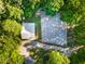 Aerial shot of a barn and horse riding arena, with lush green trees all around at 54 Malcolm Neal Path, Louisburg, NC 27549