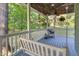 Covered back porch with wood ceiling, fan, and swing, provides a peaceful outdoor retreat at 54 Malcolm Neal Path, Louisburg, NC 27549