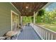 Spacious back porch with wood ceiling, fan, and wicker seating, ideal for relaxing outdoors at 54 Malcolm Neal Path, Louisburg, NC 27549