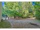 Spacious backyard with mature trees and partial fencing offers privacy and room to roam at 54 Malcolm Neal Path, Louisburg, NC 27549
