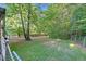 Expansive backyard with lush green lawn and mature trees offers a private retreat at 54 Malcolm Neal Path, Louisburg, NC 27549