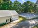 Aerial view of a horse barn, complete with an overhead garage door and nearby riding arena at 54 Malcolm Neal Path, Louisburg, NC 27549