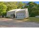Large metal barn/workshop with ample storage space and convenient roll up door at 54 Malcolm Neal Path, Louisburg, NC 27549