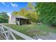 Exterior view of a well-maintained barn, surrounded by grassy fields and a sturdy white fence at 54 Malcolm Neal Path, Louisburg, NC 27549