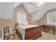 Bedroom featuring a vaulted ceiling, large window, and wooden sleigh bed at 54 Malcolm Neal Path, Louisburg, NC 27549