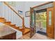 Inviting entryway showcasing the stained-glass front door and wood staircase at 54 Malcolm Neal Path, Louisburg, NC 27549